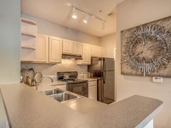 Furnished model kitchen with black appliance package